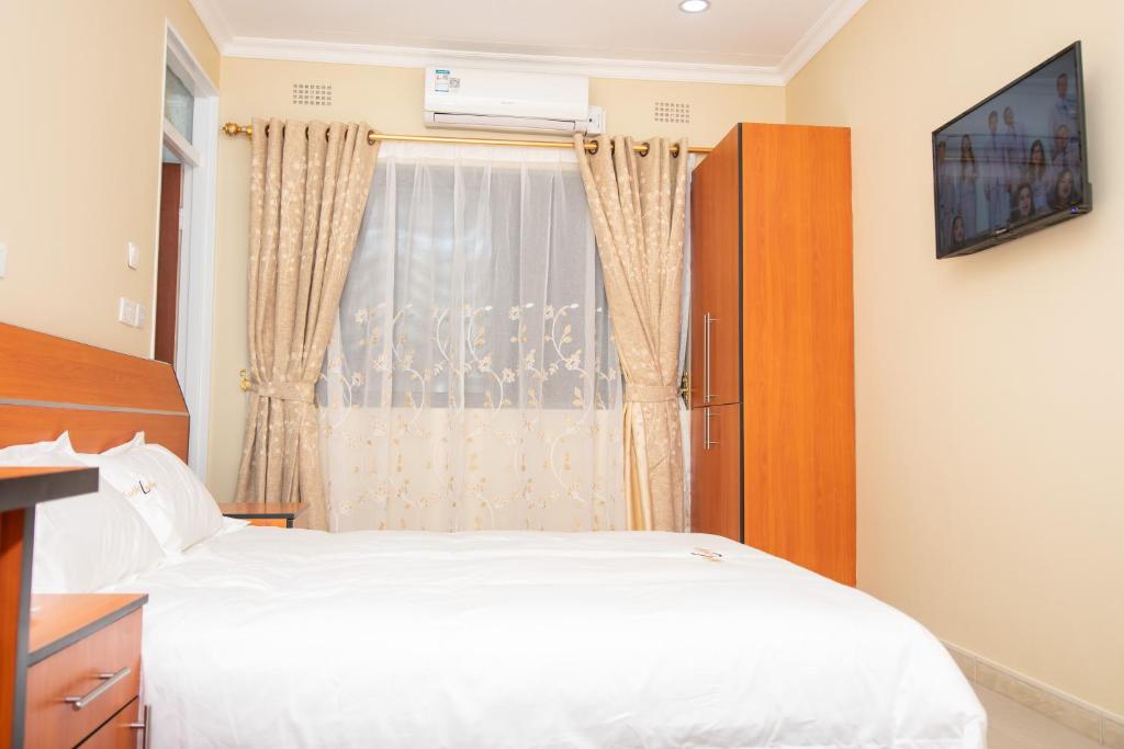 布兰太尔Travelodge的卧室配有白色的床和窗户。
