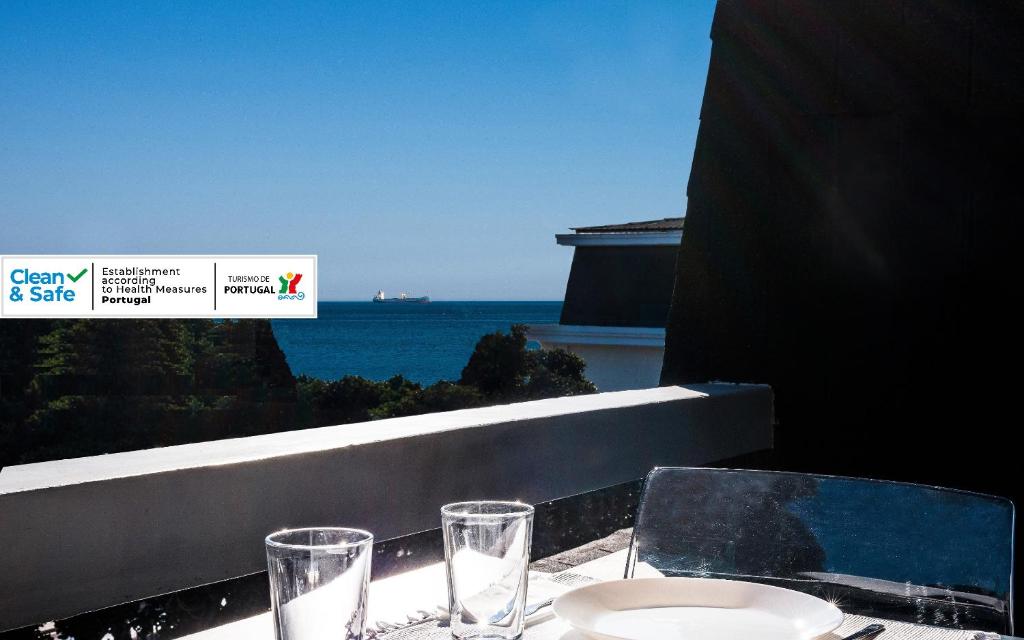 埃斯托利尔Cascais-Estoril BEACHFRONT Apartments的一张带眼镜的桌子,享有海景