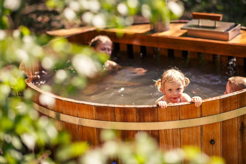 萨扎瓦河畔斯韦特拉Treehouse Stvořidla的几个孩子在热水浴缸中