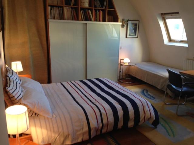 巴黎科特蒙马特住宿加早餐旅馆的一间卧室设有一张床和一个书架