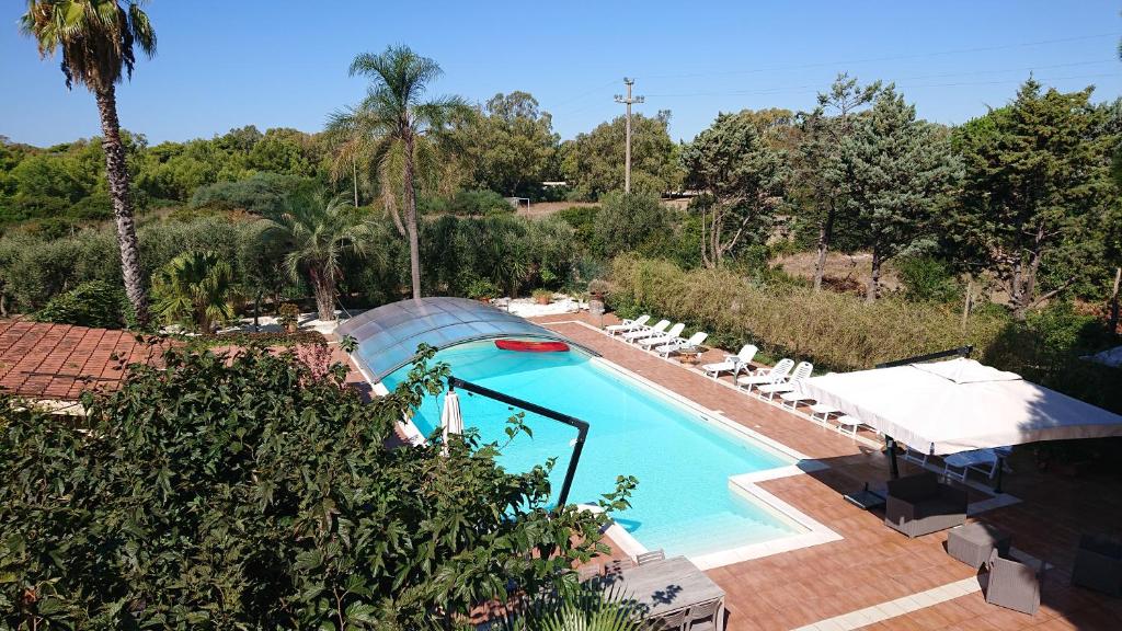 莱波拉诺A12-Masseria Villa Gandoli-Piscina的享有棕榈树游泳池的顶部景致
