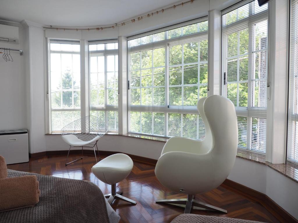 欧德鲁佐PR乌纳埃斯特雷亚多拉达酒店的客厅配有两把白色椅子和窗户