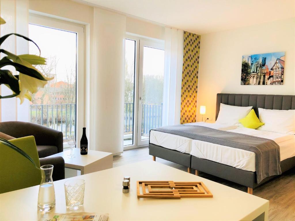 布伦瑞克ADAPT Apartments Braunschweig的一间卧室设有一张床和一间客厅。