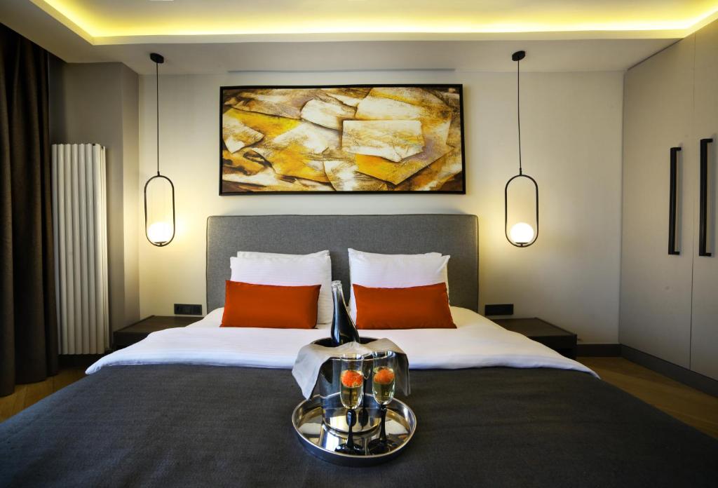 伊斯坦布尔The Capital Hotel的一间卧室配有一张带橙色枕头的大床