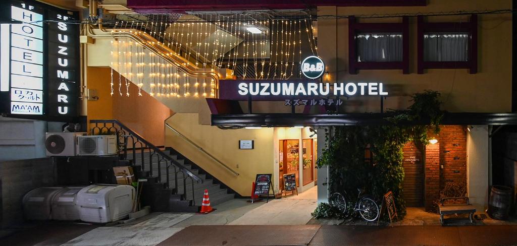 和歌山Suzumaru Hotel的一座有标志的建筑,上面有读取地铁酒店的标志