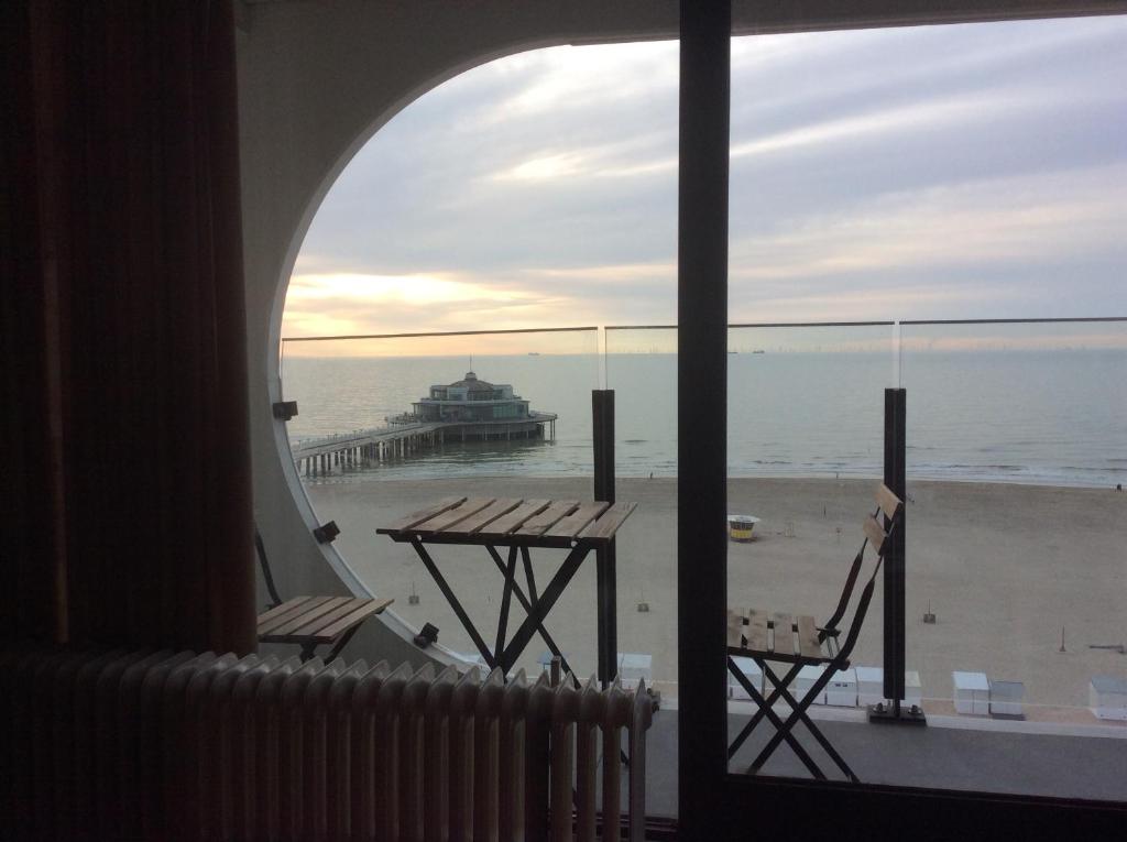 布兰肯贝赫Isola Bella的配有桌椅的客房享有海滩美景。