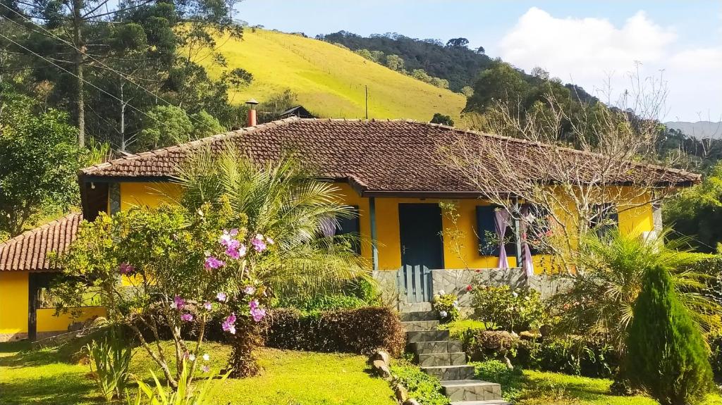 维奥康德马奥Casa do Osorio的一座黄色房子,后面有一座小山
