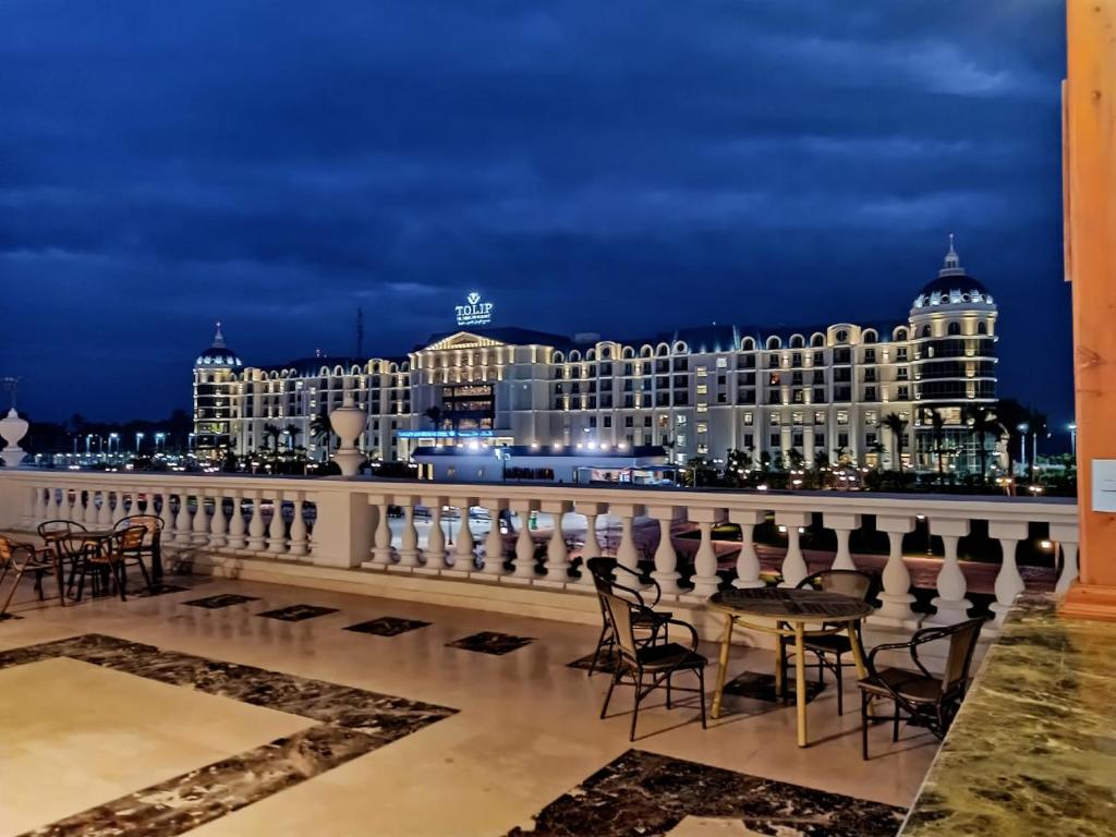 伊斯梅利亚托力普埃尔弗桑酒店的享有大楼的夜间景致,配有桌椅