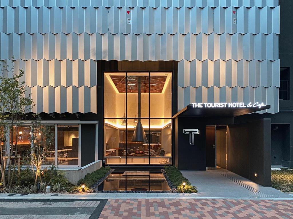 东京THE TOURIST HOTEL & Cafe AKIHABARA的一座建筑,上面有读导师酒店的标志