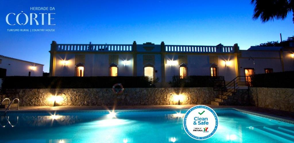 塔维拉赫达德达科尔特酒店的一座在晚上设有游泳池的大房子