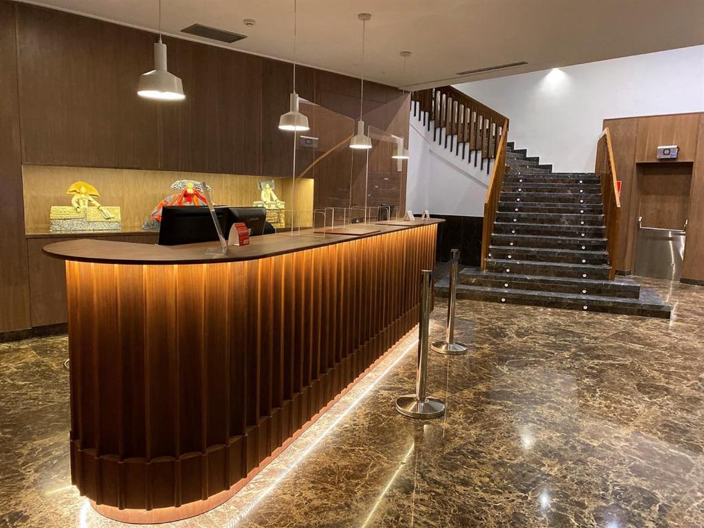 昆卡托雷曼加纳酒店的大楼内带酒吧和楼梯的大堂