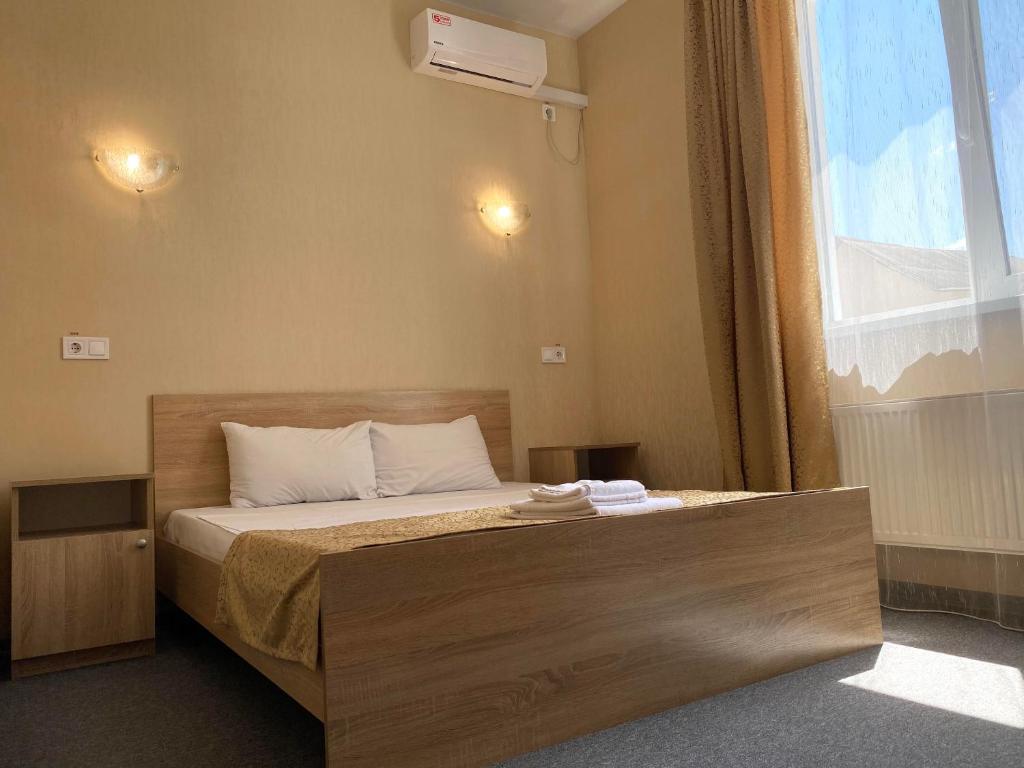 基辅Guest House SOTNI的一间卧室设有一张大床和大窗户