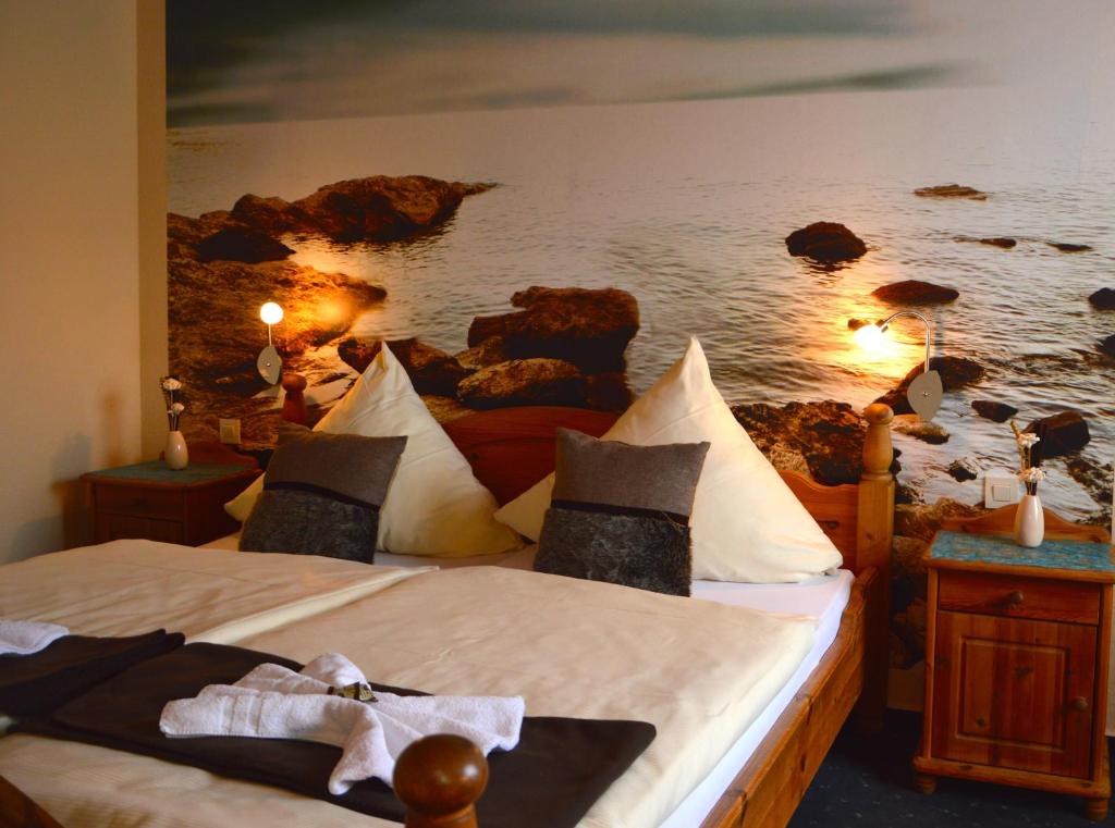 Bexbach盖斯特豪斯克朗酒店的一间卧室配有两张床,并画着海洋