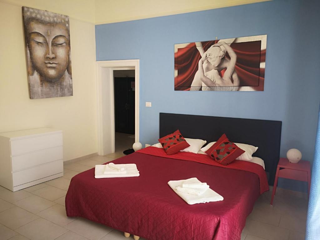 焦维纳佐Il Da Vinci casa vacanze的一间卧室配有一张红色床罩的床