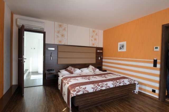 海德克塞博德斯穆旅馆的一间卧室设有两张床和橙色的墙壁