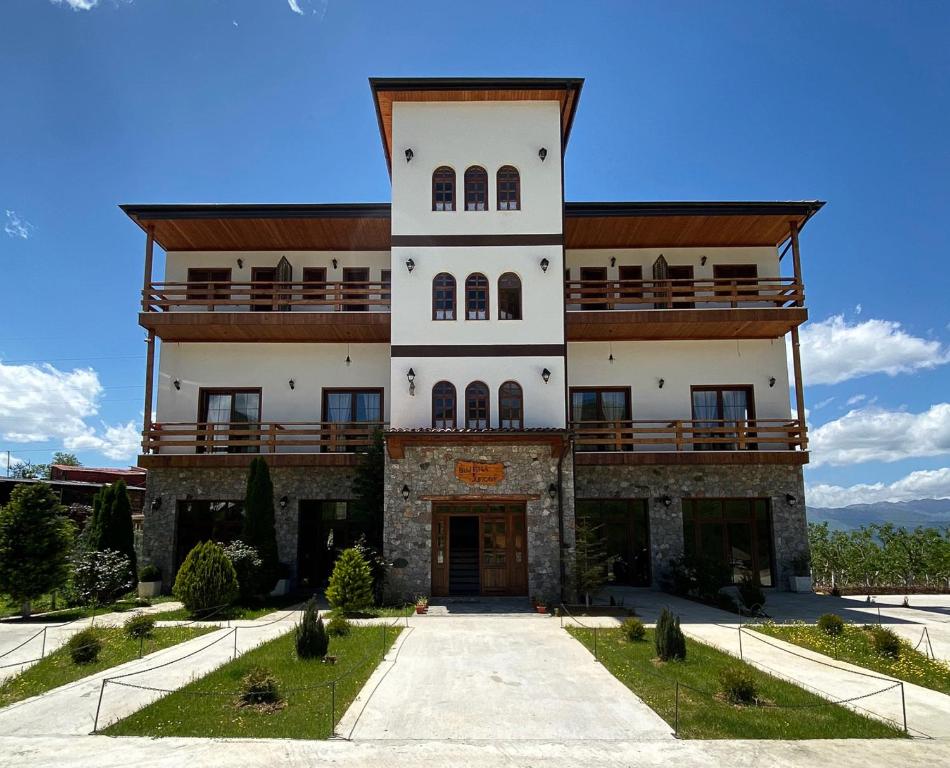 PeshkopiNëna Dashuri Agroturizëm的一座大型建筑,上面设有阳台