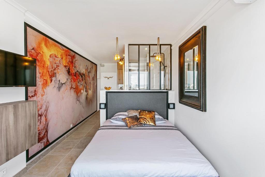 阿格德角Cap d'Agde Studio - Village naturiste的卧室配有一张床,上面放着一只猫