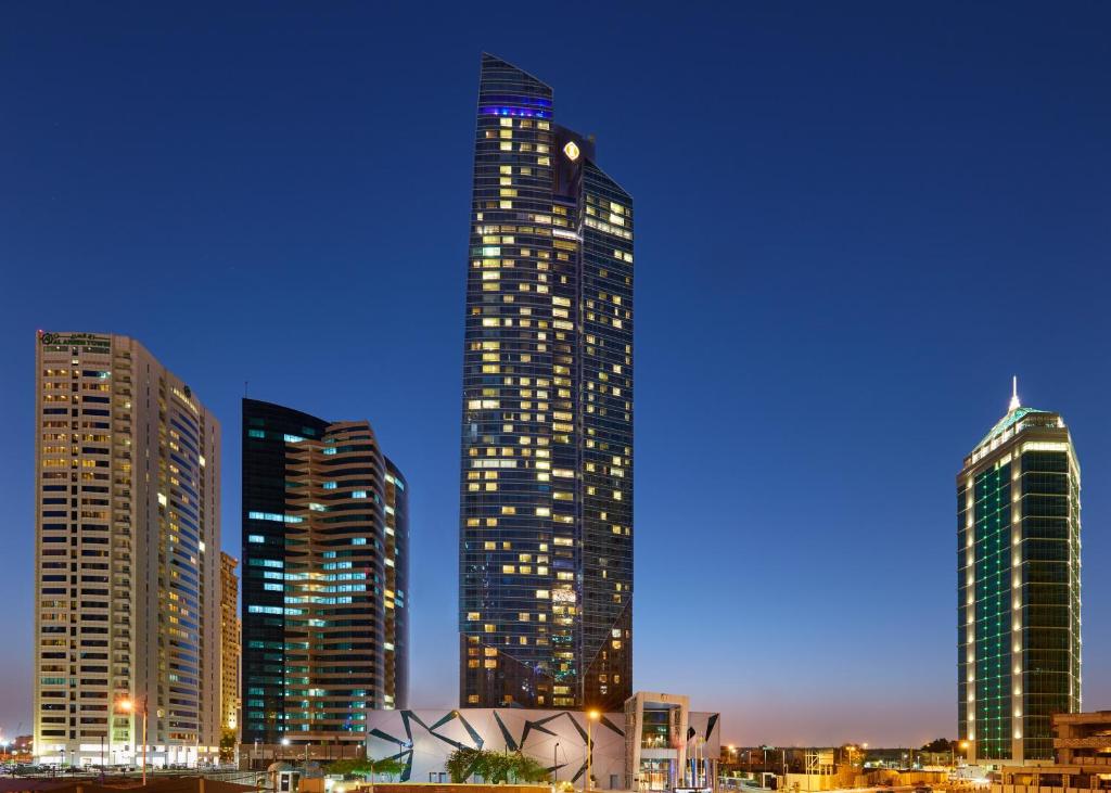 多哈InterContinental Doha The City, an IHG Hotel的夜晚在城市的高楼