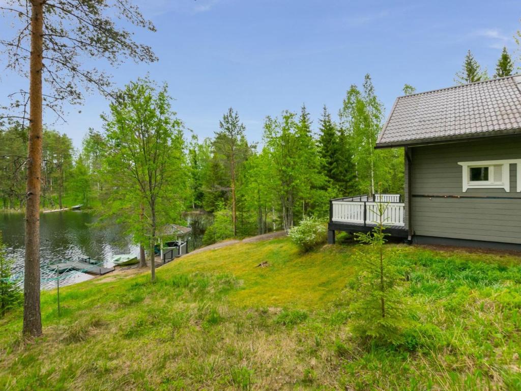HankamäkiHoliday Home Kiikkukallio by Interhome的水边有长凳的房子