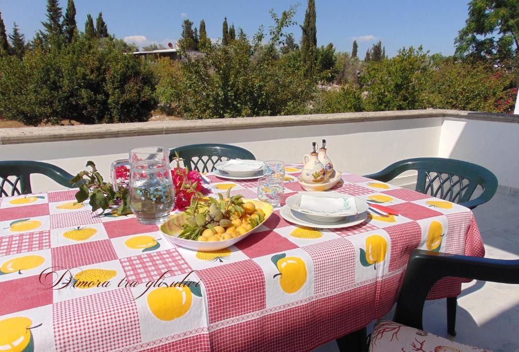 托雷苏达Dimora tra gli ulivi的一张桌子,上面有水果,上面有桌布
