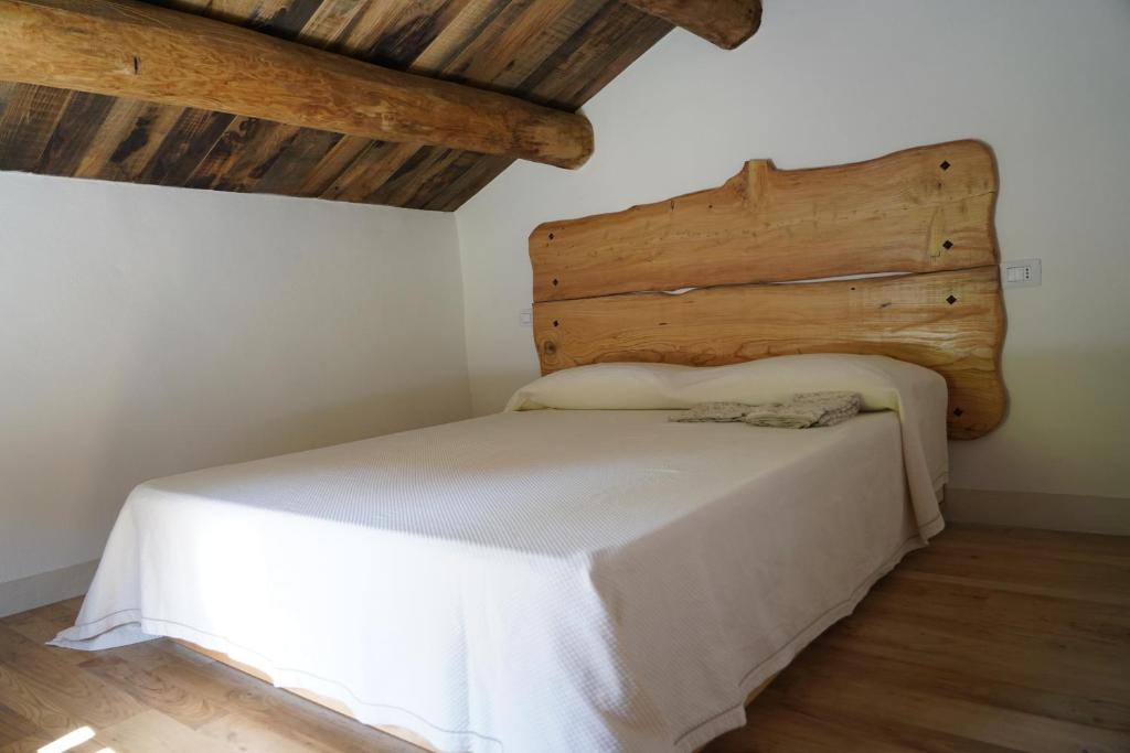 巴尼奥迪罗马涅Casina del Ponte的木制天花板的客房内的一张床位