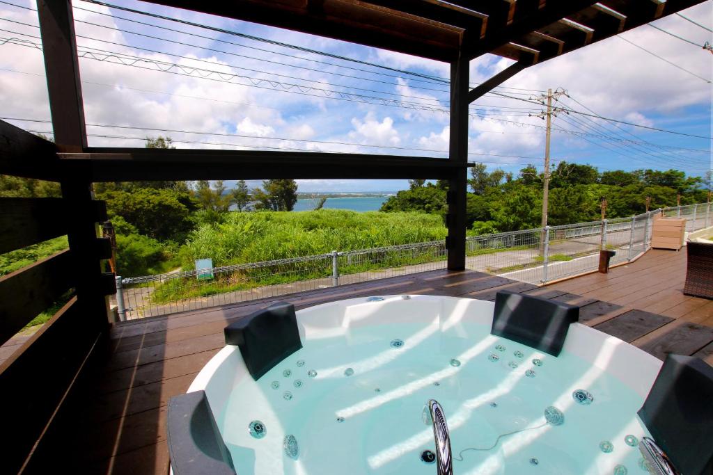 宜野座Beach Side Secret -SEVEN Hotels and Resorts-的海景甲板上的浴缸