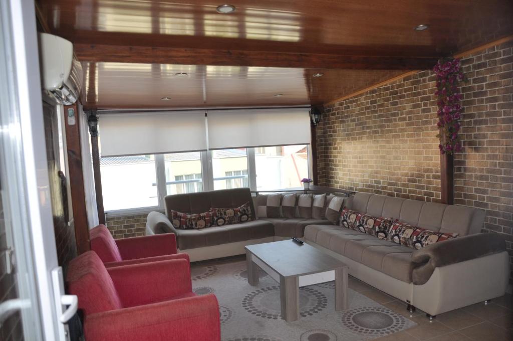 埃杰阿巴德巴尔西公寓的带沙发和椅子的客厅以及砖墙