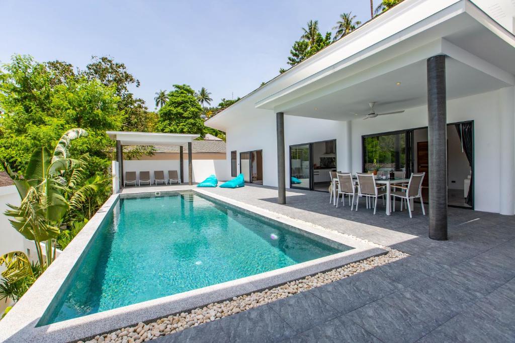 苏梅岛Villa Nirvana, 3 Bedrooms, Chaweng Noi的一座房子后院的游泳池