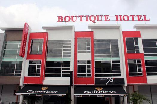 马六甲906 Hotel Kota Laksamana的一座红白色的建筑,与美食酒店