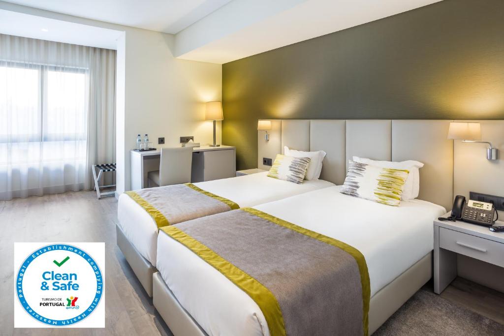 里斯本里斯本帝国酒店的酒店客房设有一张大床和电话