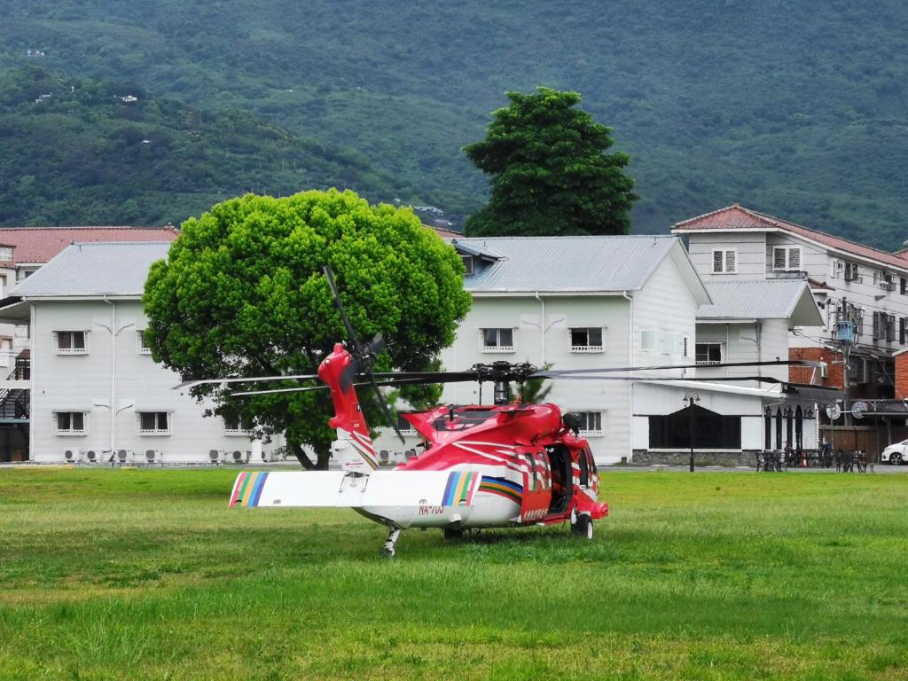 花莲市欧客庄园的停在大楼前的一块田野上的红色直升机