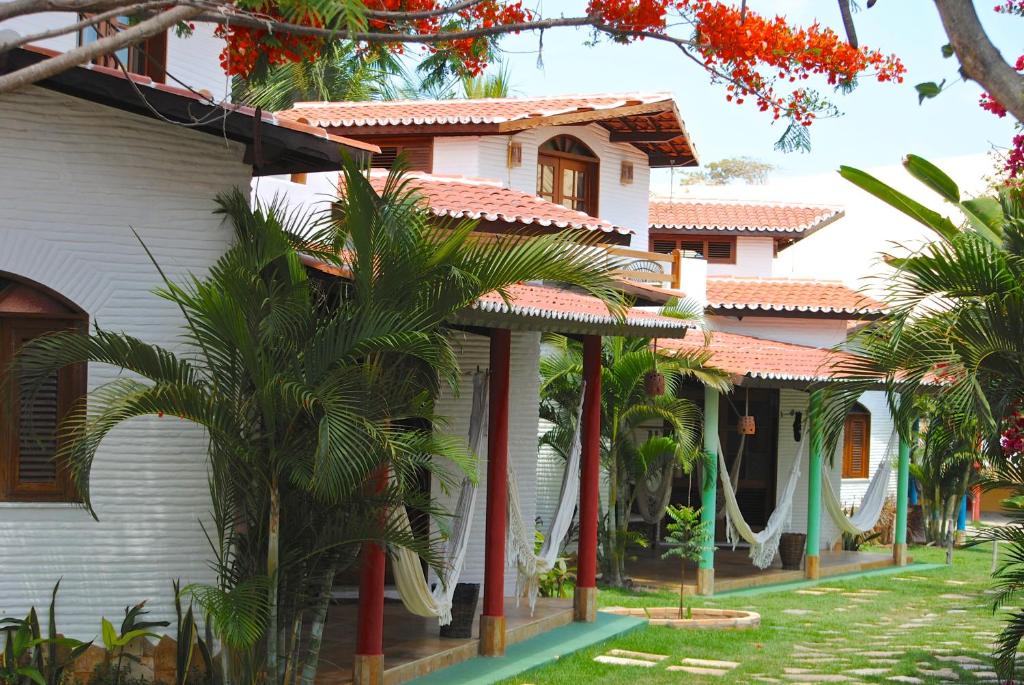帕拉库鲁Paracuru Kite Village的前面有棕榈树的房子