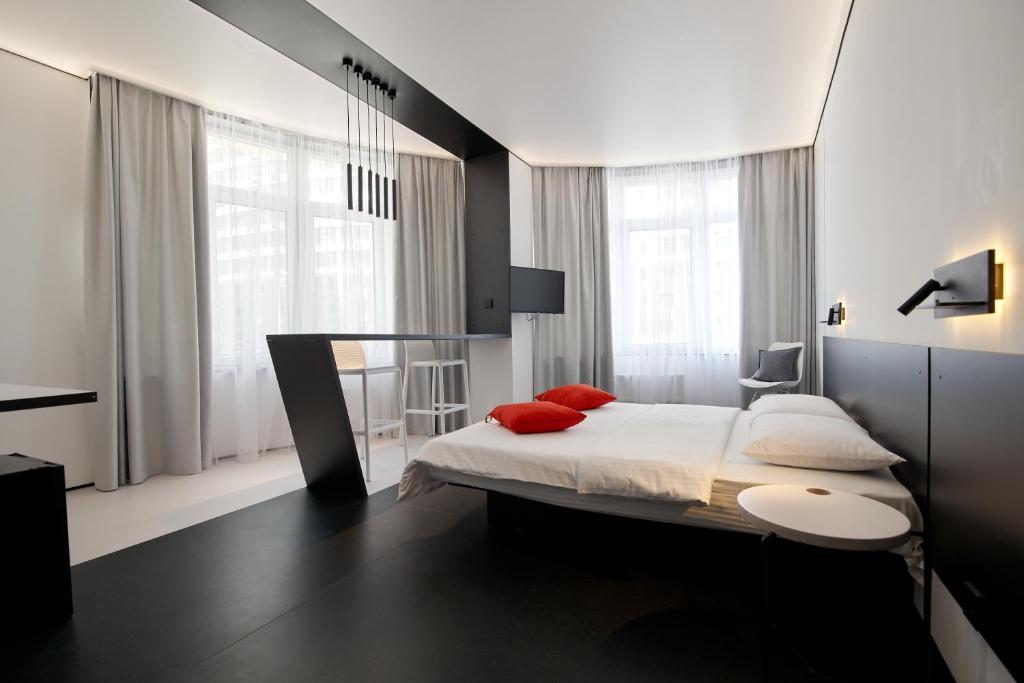 敖德萨Atmosfera Hotel的一间卧室配有一张带红色枕头的大床