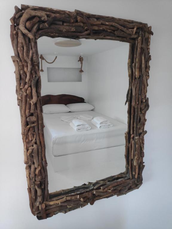 瓦西Aletri & Orgoma的镜子反射着房间里的一张床