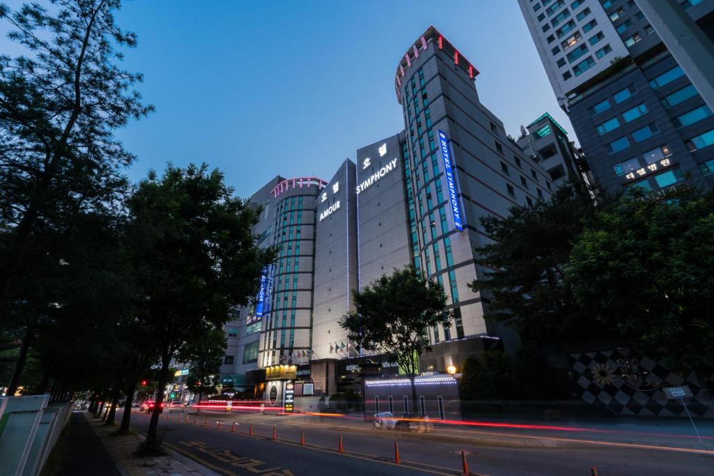 水原市Symphony Hotel的一条城市街道,晚上有高大的建筑