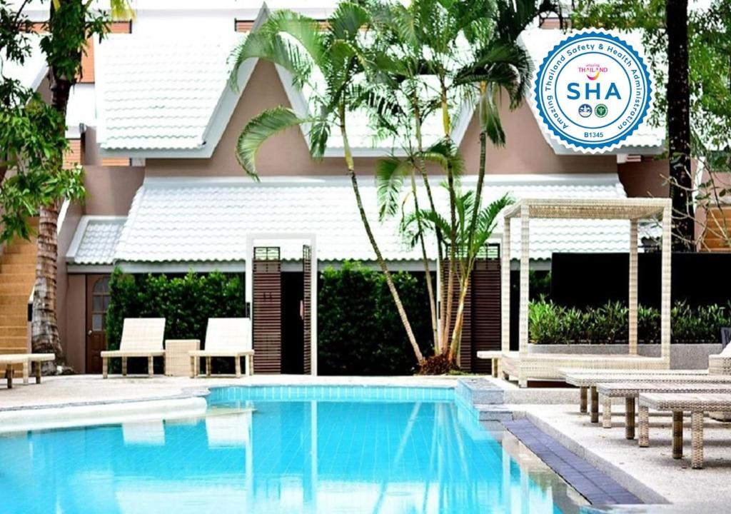 奥南海滩Deevana Krabi Resort - SHA Extra Plus的一座带酒店标志的建筑前的游泳池