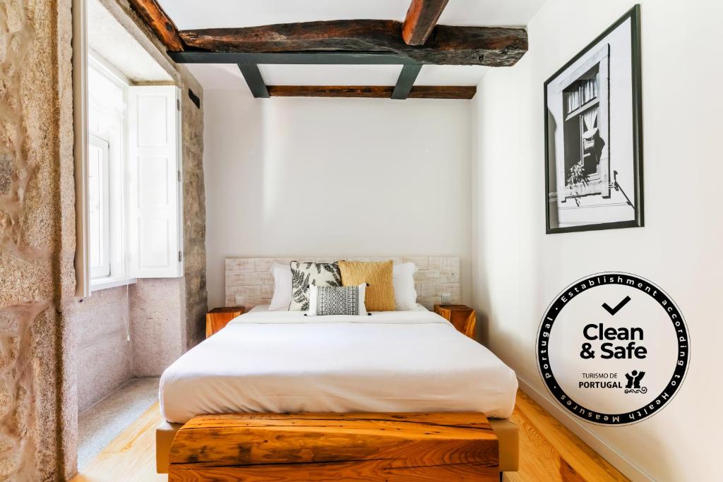 波尔图居家公寓的一间卧室,配有一张床和一个写有干净和保险箱的标志