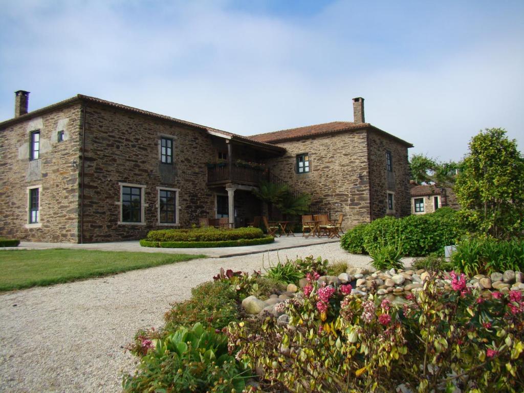 阿尔苏阿圣玛丽亚帕索旅馆的一座石头房子,前面设有花园