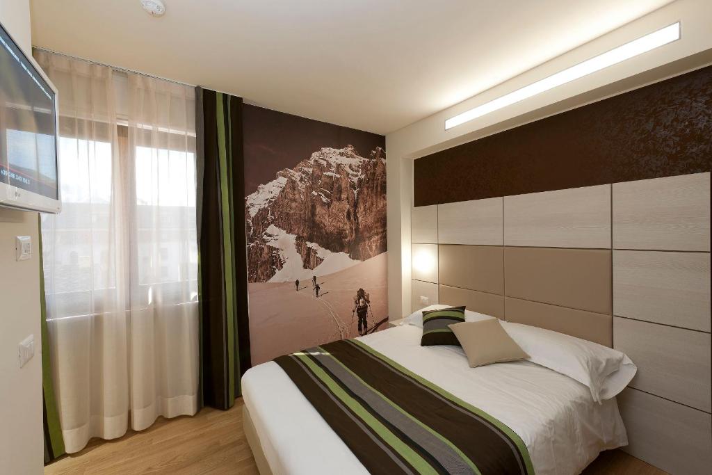 HB Aosta Hotel & Balcony SPA客房内的一张或多张床位
