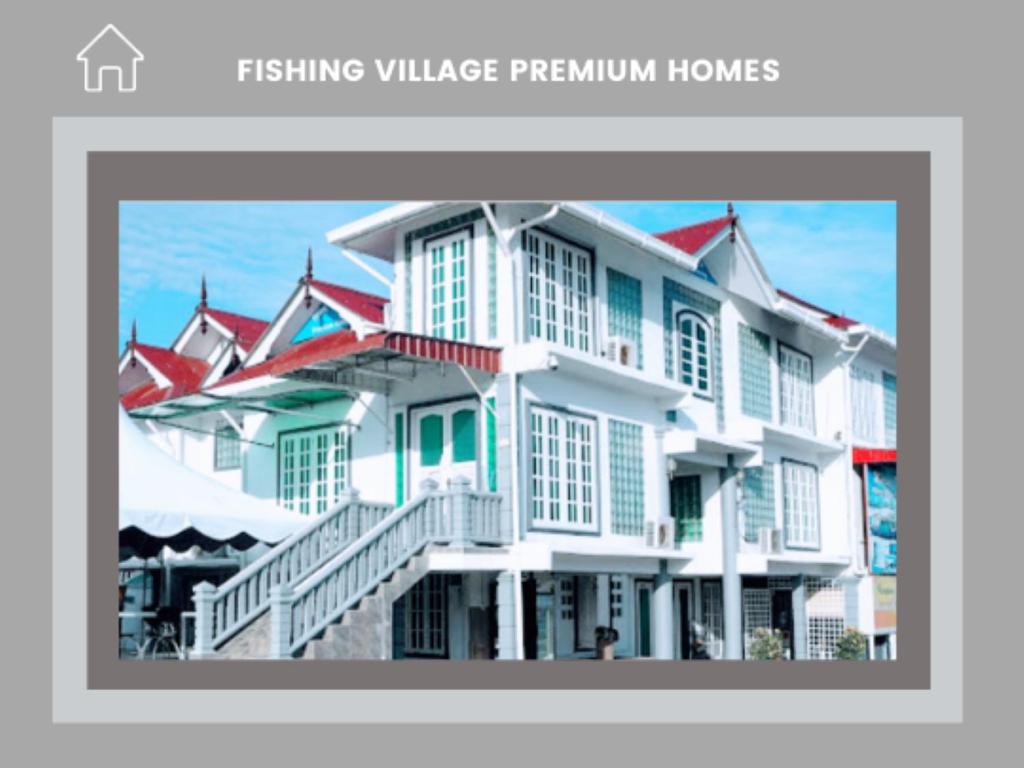 马兰Fishing Village Marang Terengganu的一座白色的大建筑,有红色的屋顶