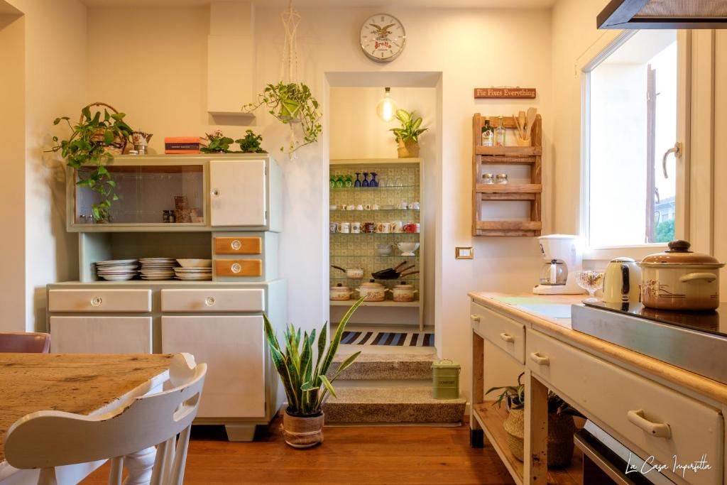 特雷维索La Casa Imperfetta的厨房配有柜台和桌子