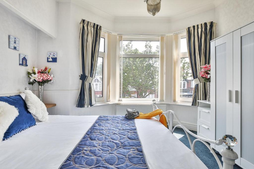 斯卡伯勒肯辛顿酒店的一间卧室设有一张床和两个窗户。
