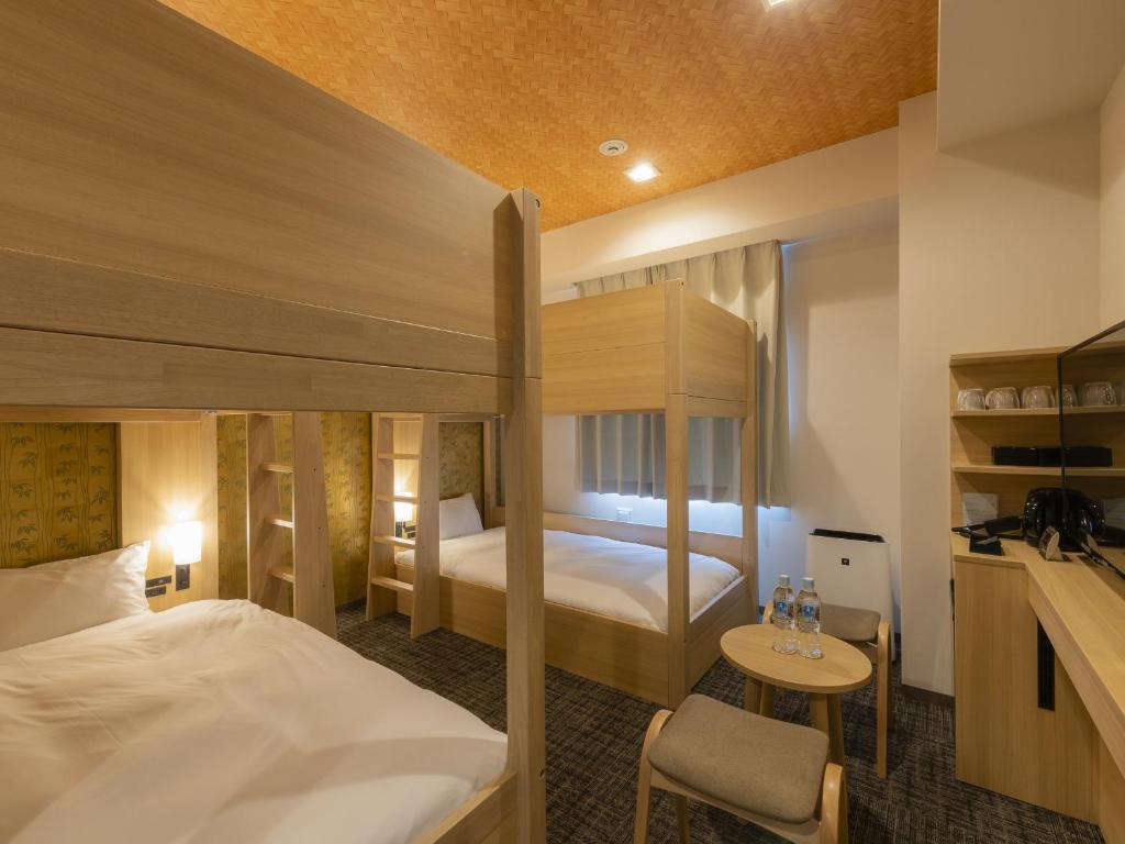 东京Tosei Hotel Cocone Asakusa Kuramae的酒店客房配有一张床和一张双层床。