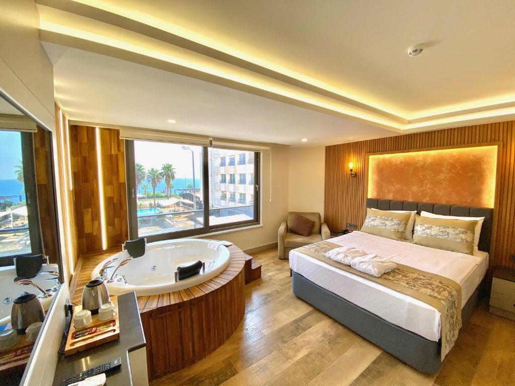 安塔利亚Green Beyza Suites的一间卧室设有浴缸和一张美景床。
