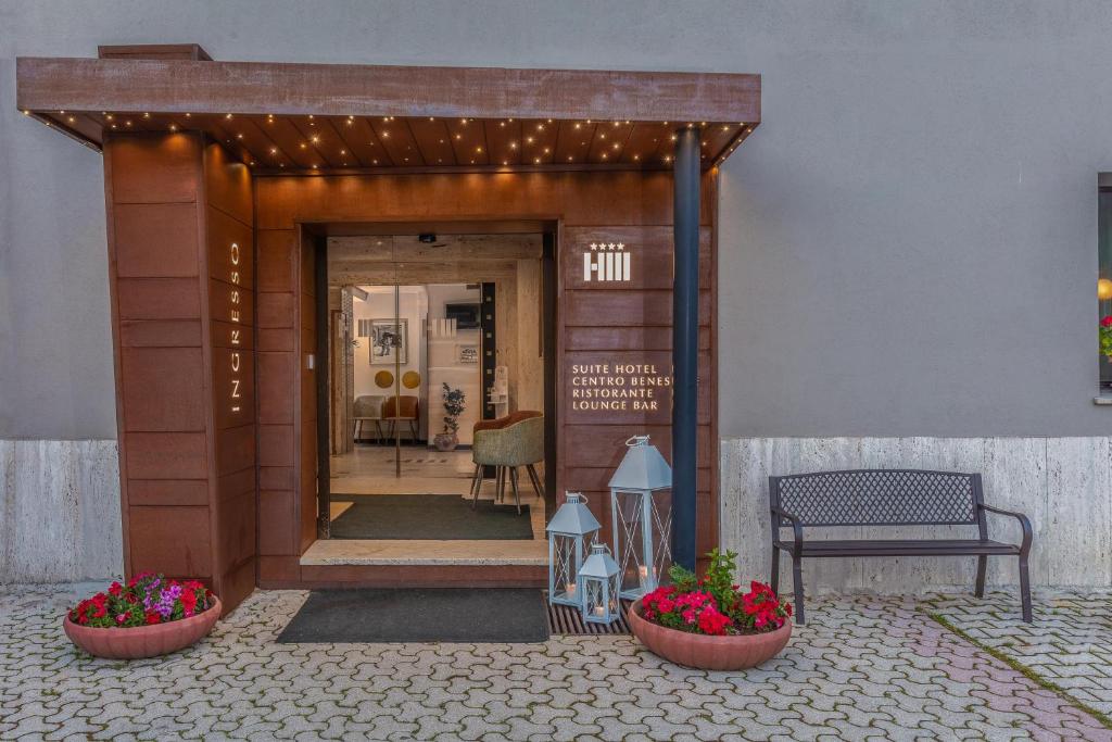 圣马西莫米勒托酒店的两座花盆和长凳的建筑物入口