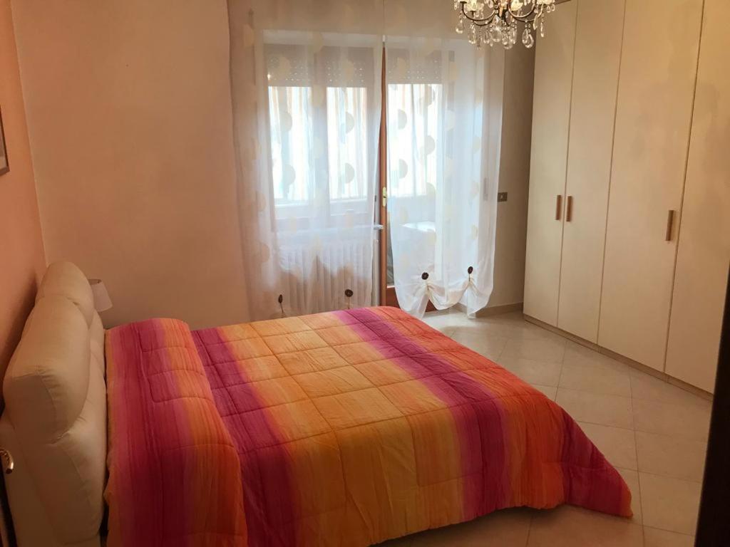 BussoLux Appartamento的一间卧室配有一张带彩色毯子的床