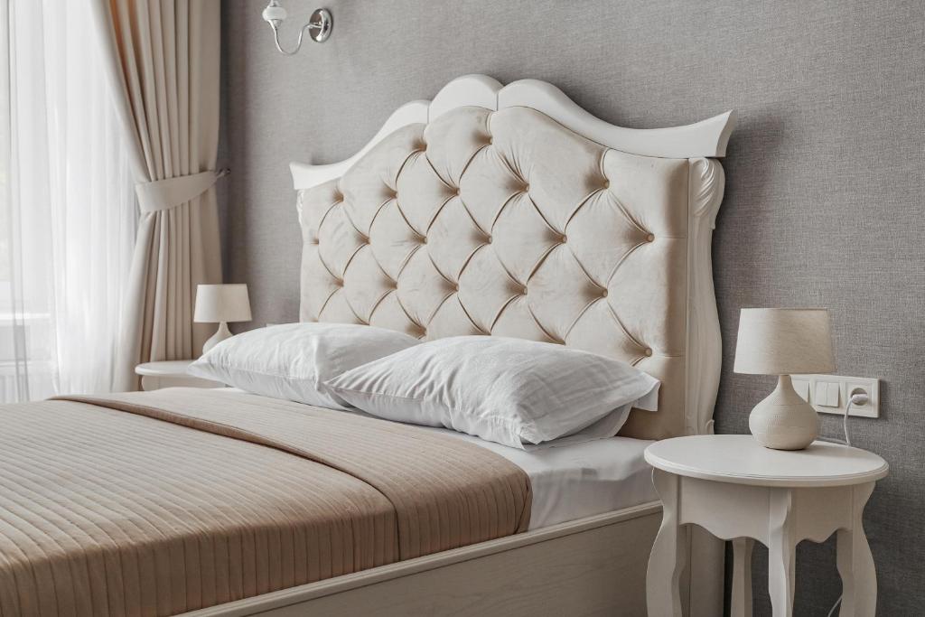敖德萨Apartments MaisoNº11的卧室配有一张白色的床和大型床头板