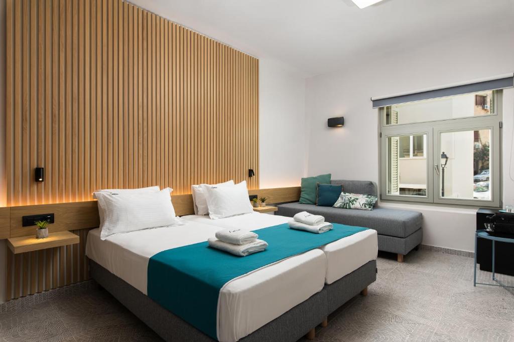 干尼亚Lignum Suites Chania的带一张大床和一张沙发的卧室