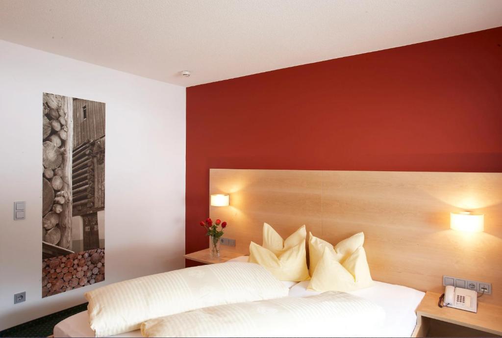 加舒恩桑布里克酒店的卧室配有白色的床和红色的墙壁