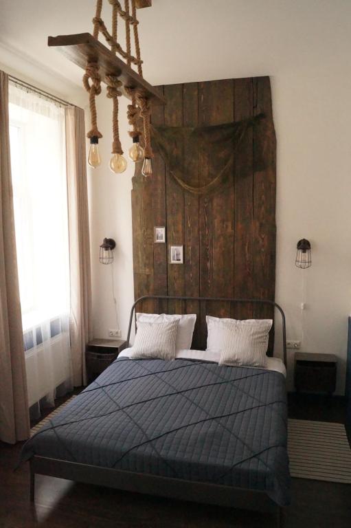 里加DABA Mini Hotel的一间卧室配有一张带大型木制床头板的床